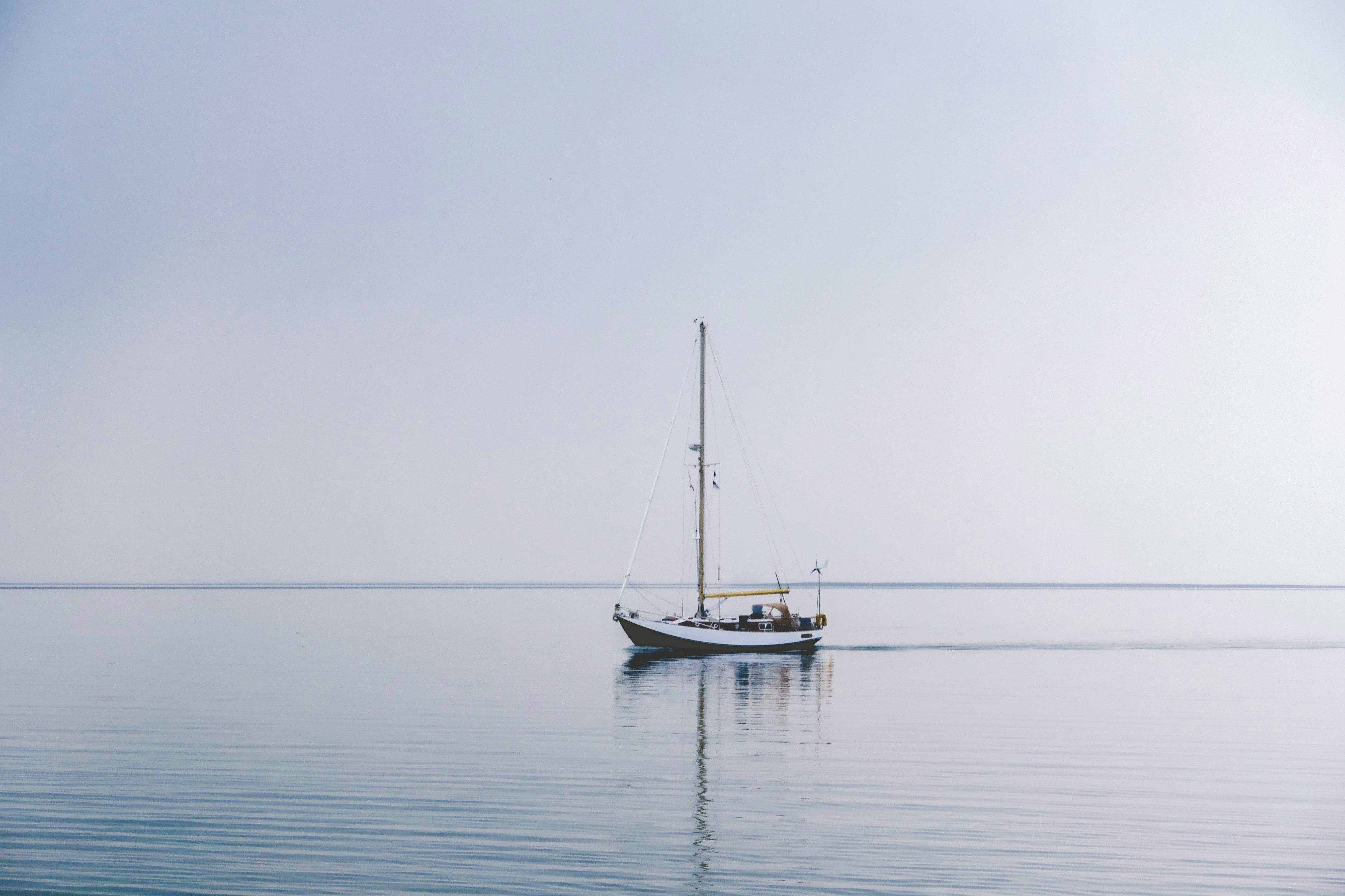 white boat in middle of ocean during daytime